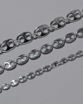 Closeup details of the CRZM Sterling Silver Yuba Mini Necklace, Sterling Silver Yuba Medium Necklace, and Sterling Silver Yuba Necklace on light color background.