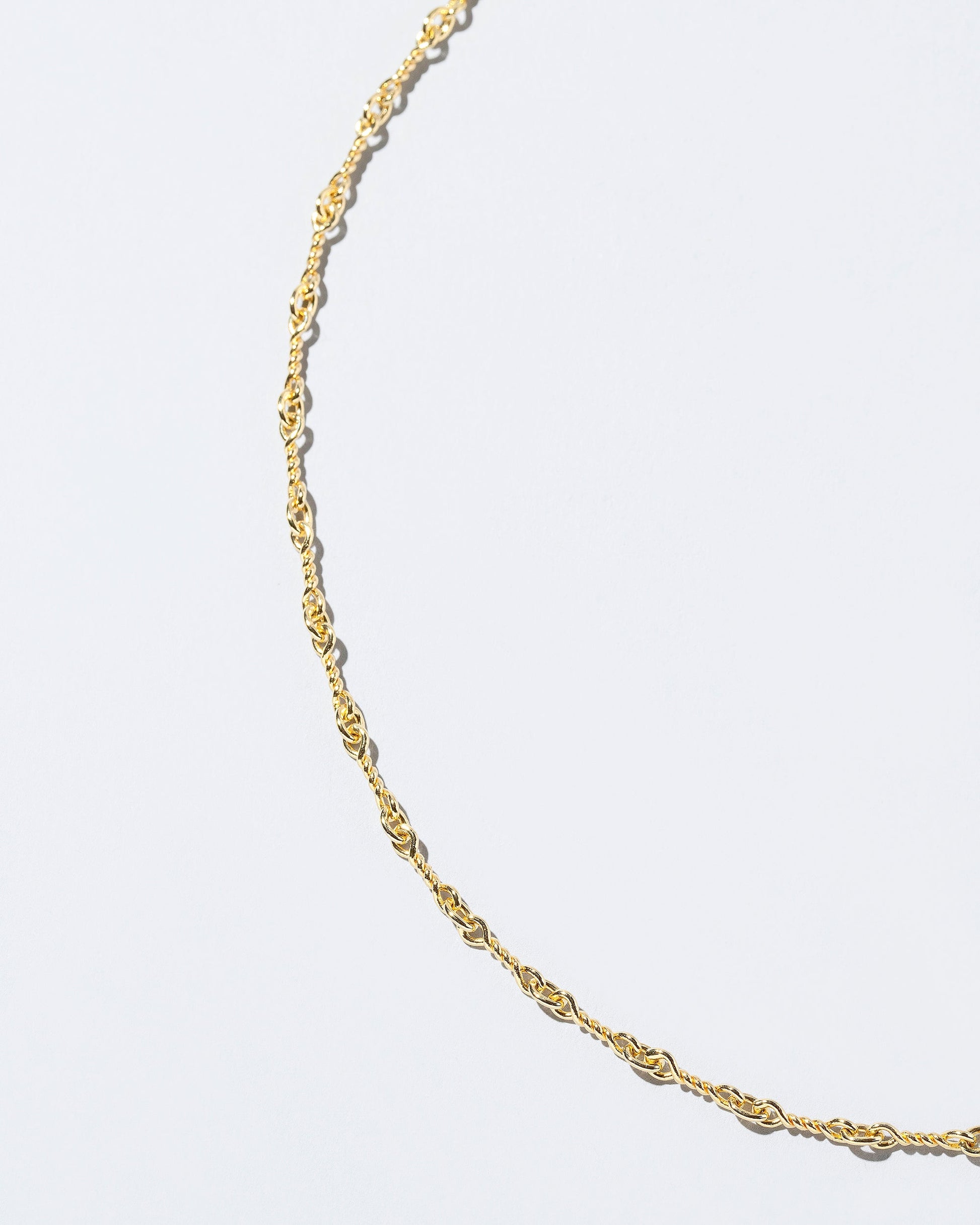 Closeup detail of the  Twisted Chain Bracelet on light color background.