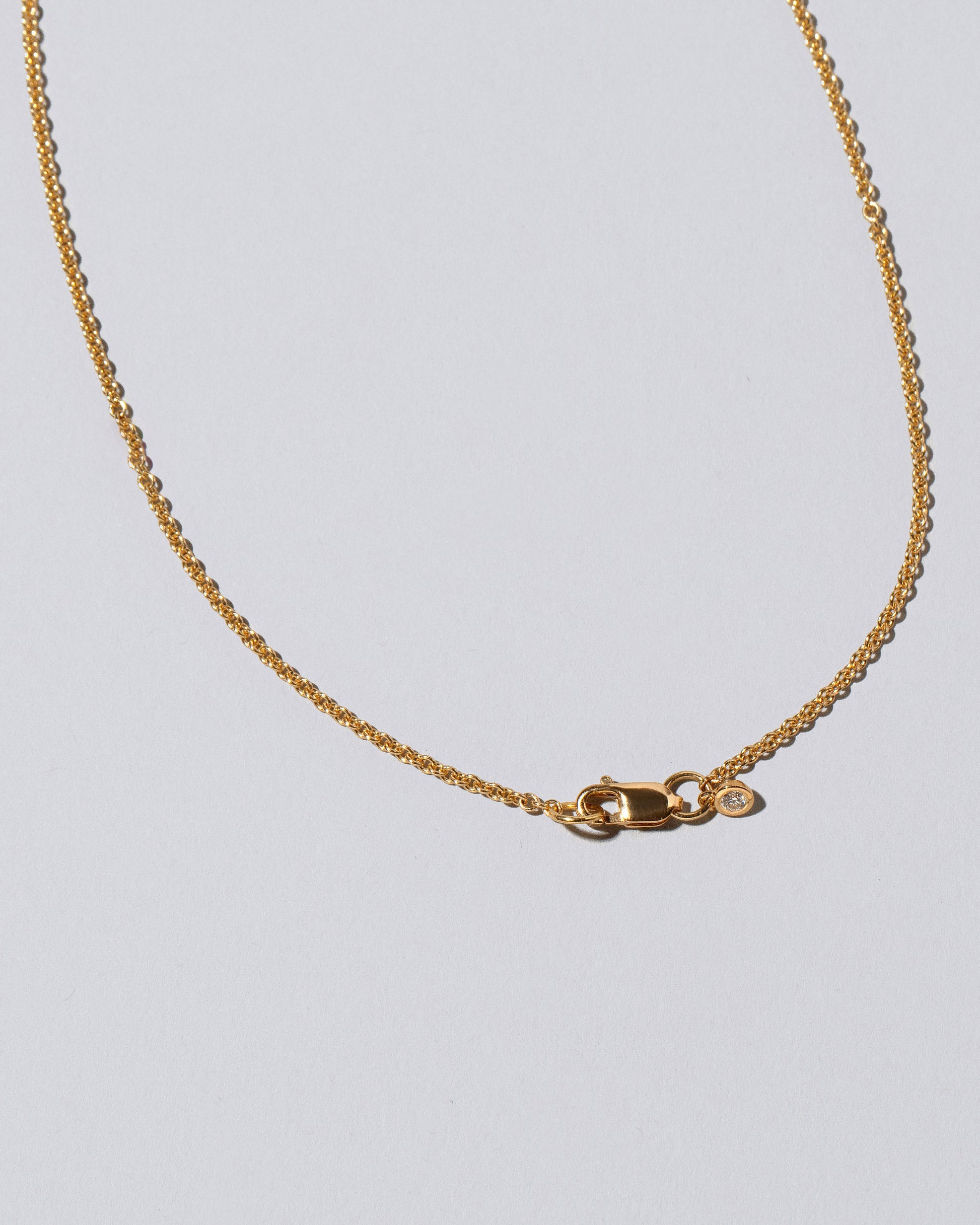 View from the back of the Purity Necklace on light color background.