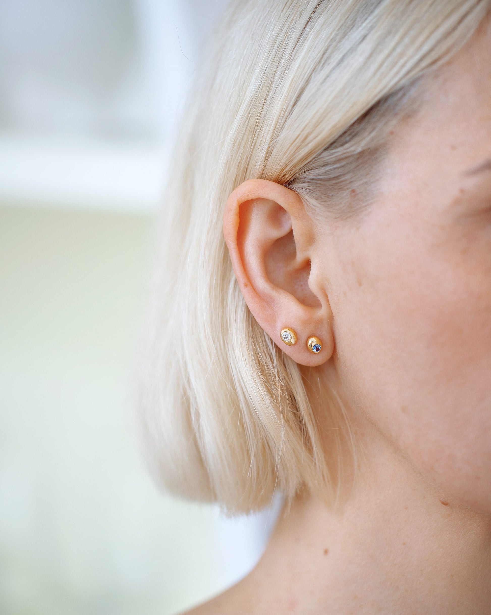 Diamond and Sapphire Birthstone Level Stud Earrings on model.