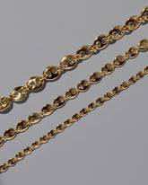 Closeup details of the CRZM  Gold Bedrock Mini Bracelet,  Gold Bedrock Medium Bracelet, and  Gold Bedrock Bracelet on light color background.