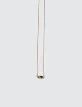 Product photo of Fin Necklace on a light color background 