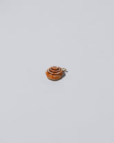 Cinnamon Roll Charm - Enamel  on light colored background