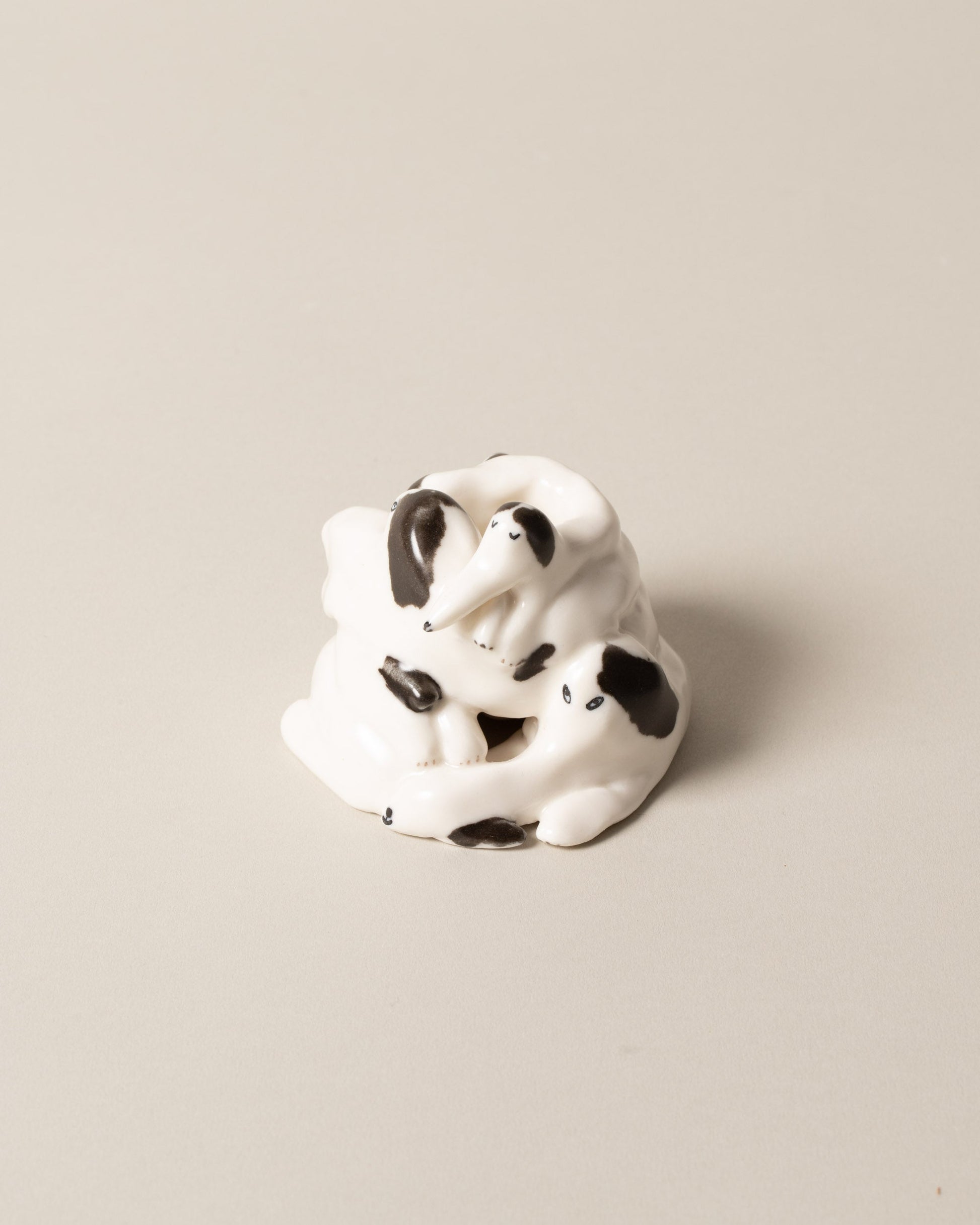Eleonor Boström Spots Dog Pile on light color background.