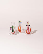 Group of FACEVESSEL Large Bud Vases on light color background.