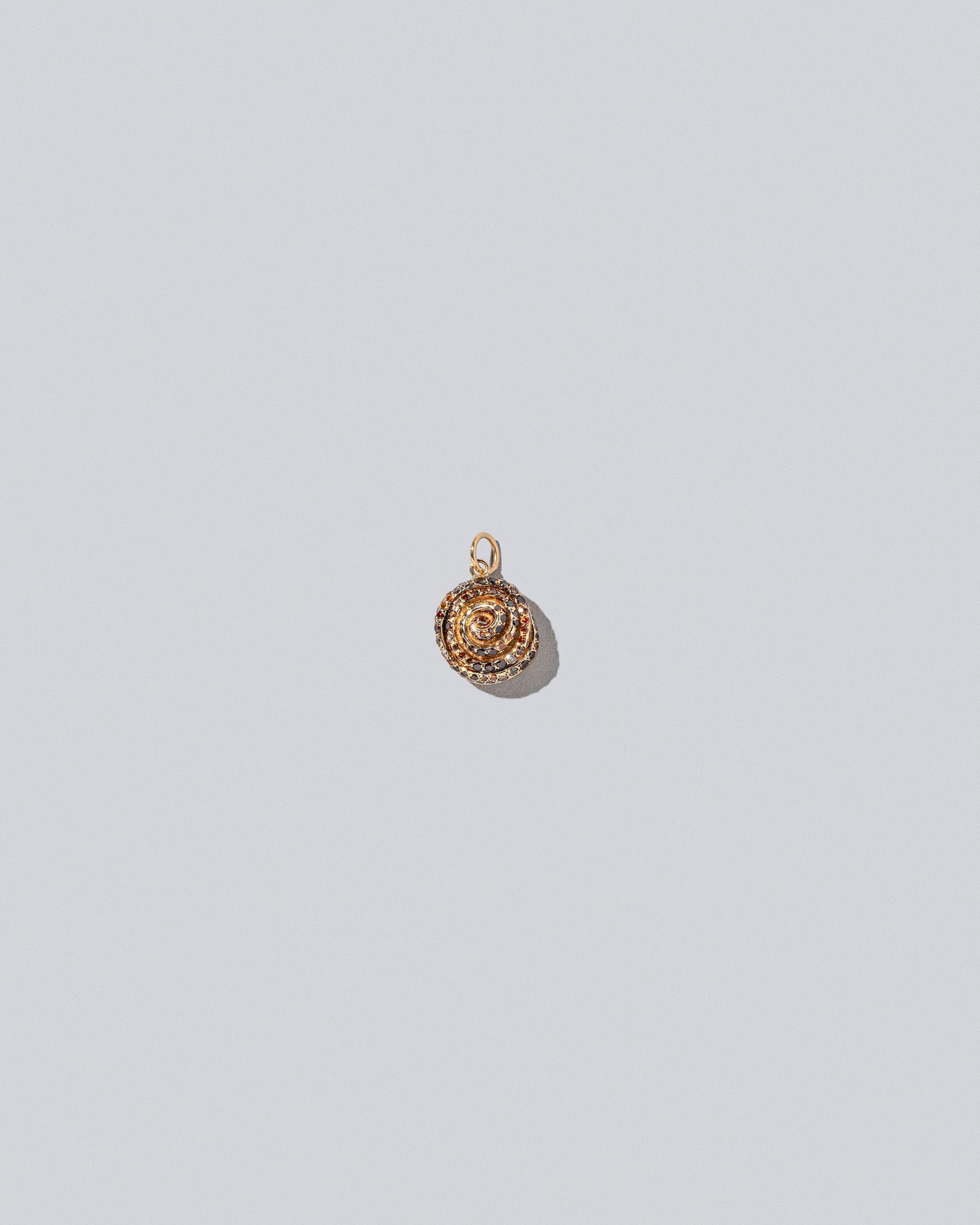Cinnamon Roll Charm - Pavés on light color background.