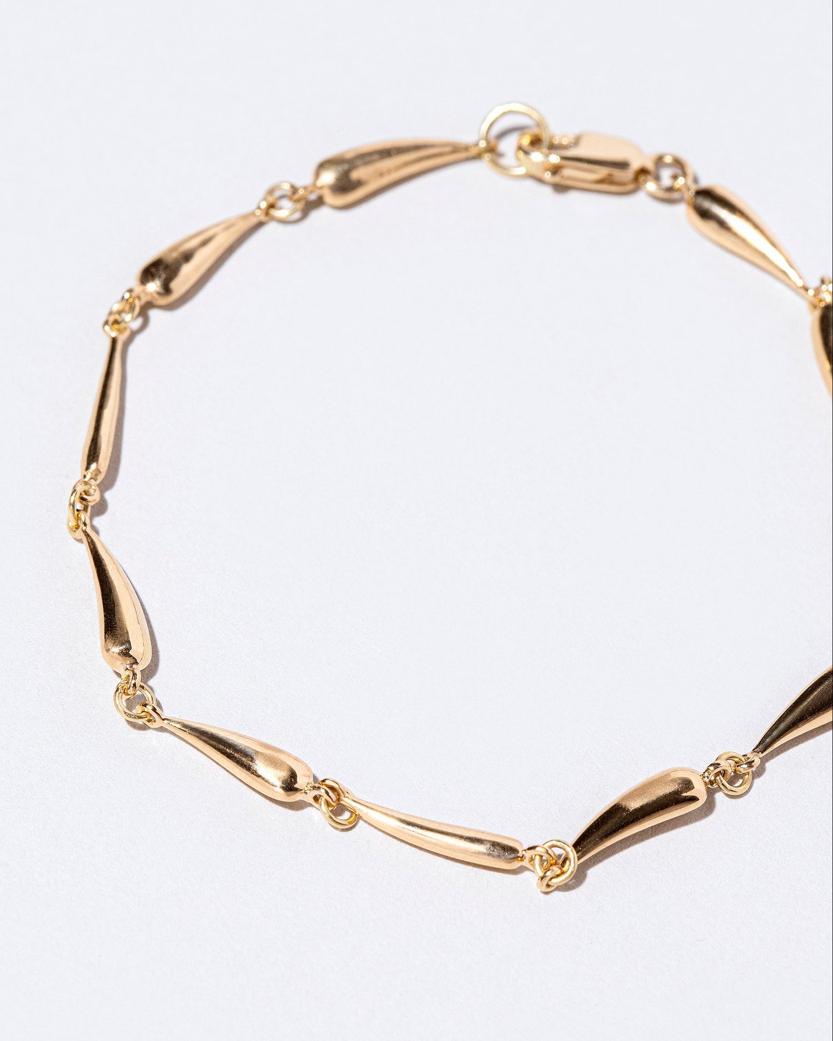 Closeup details of the Accumulation Bracelet on light color background.