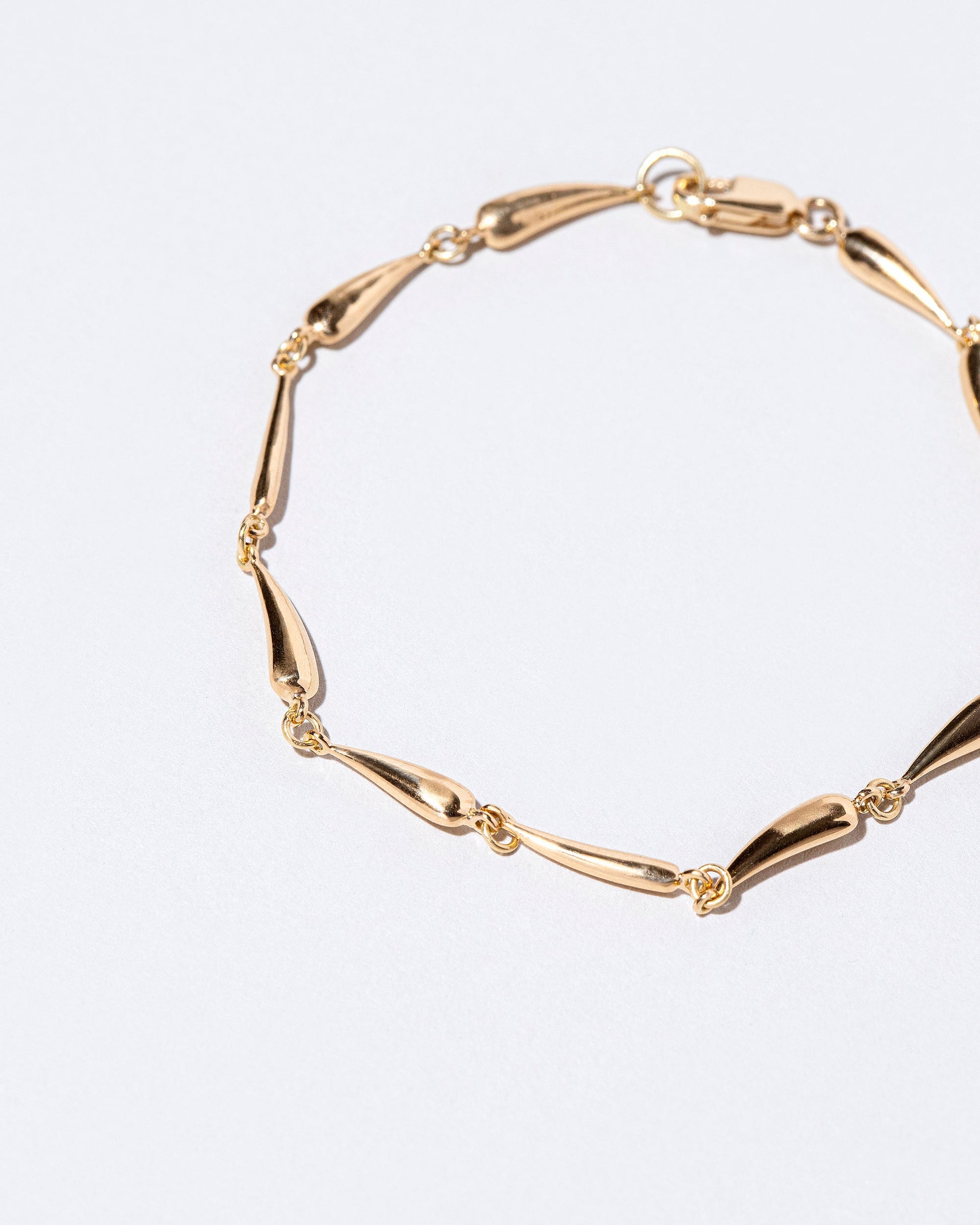 Closeup details of the Accumulation Bracelet on light color background.