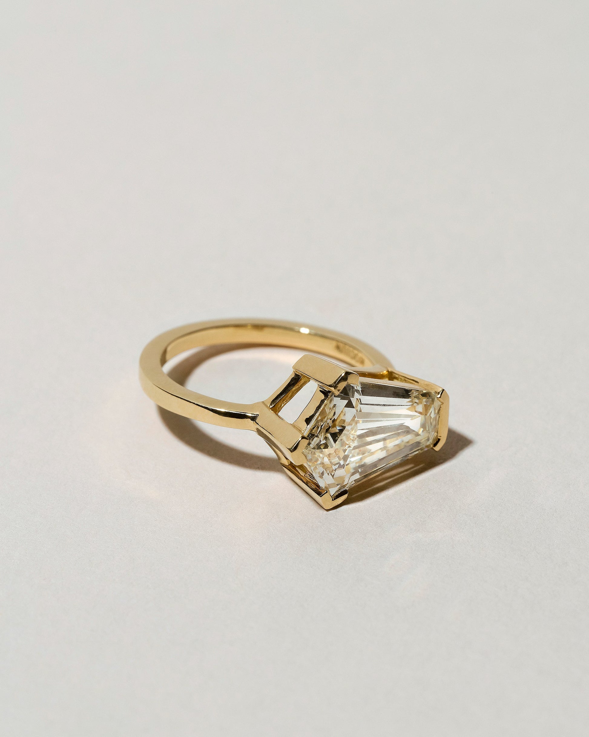 View from the side of the Modified Step Cut Diamond Ring on light color background.