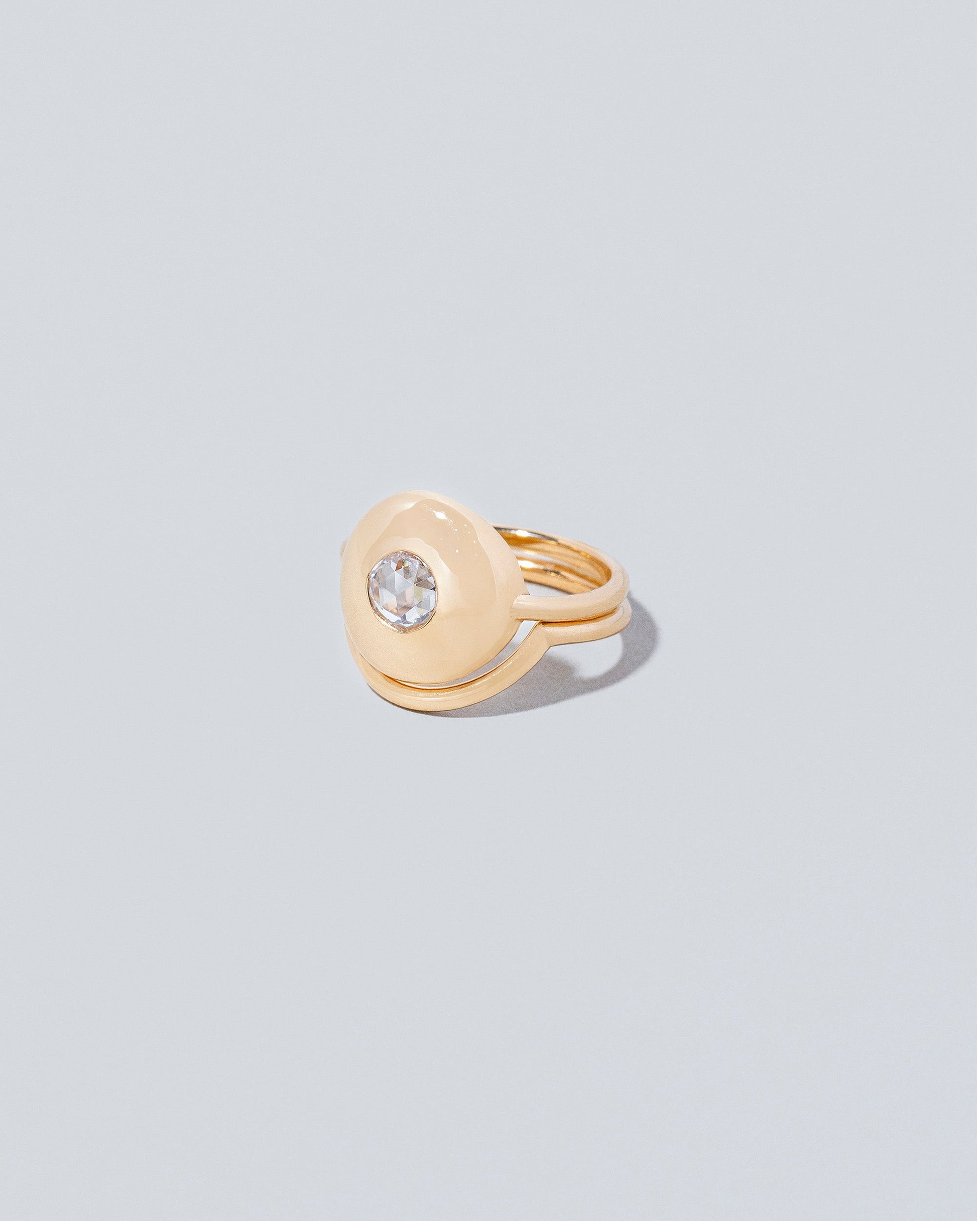 Left side view of Petite Exposition Ring with Exposition Band on light color background.