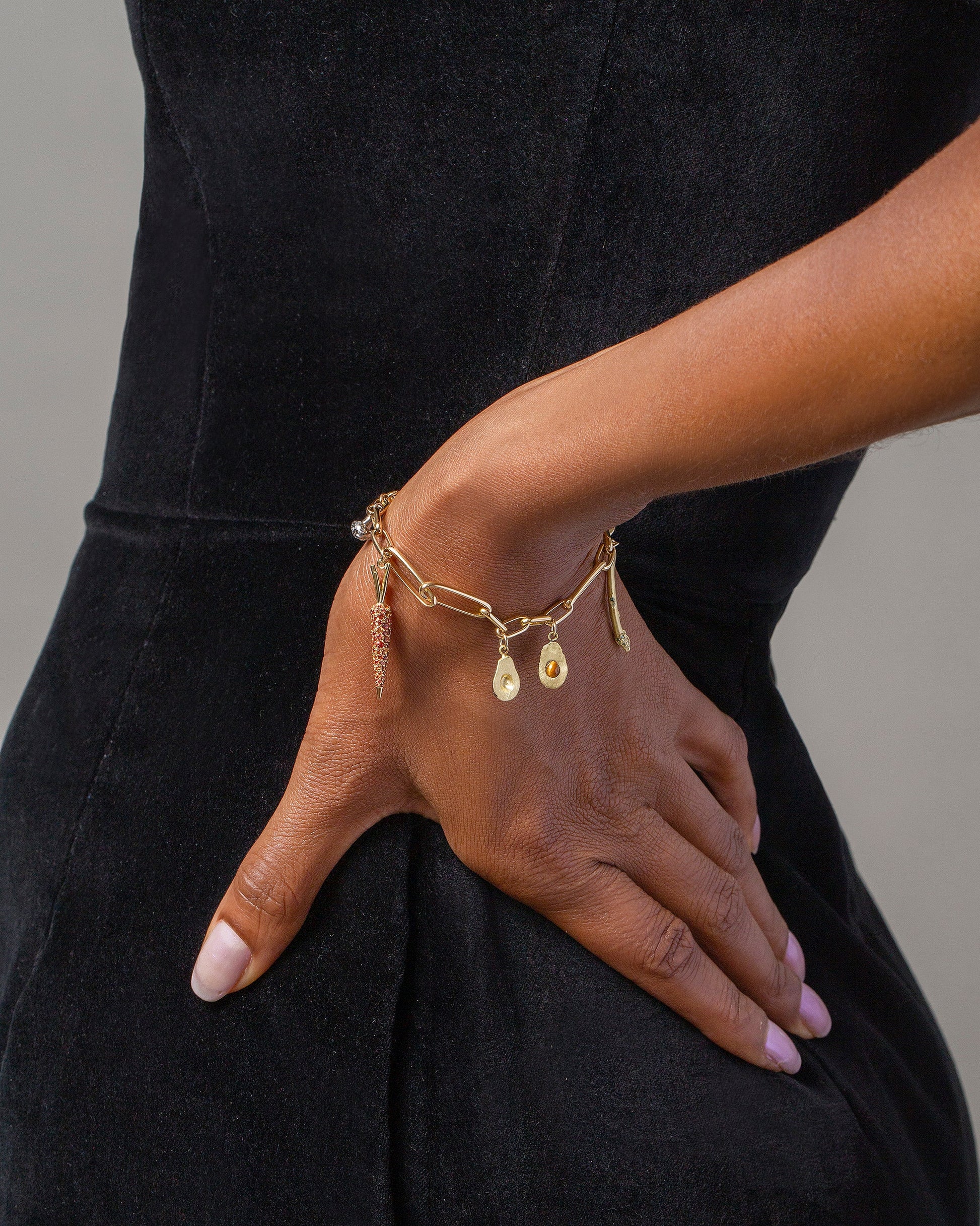 Halved Avocado Charms, Asparagus Charm, Carrot Charm and Long Loop Chain Bracelet on model.