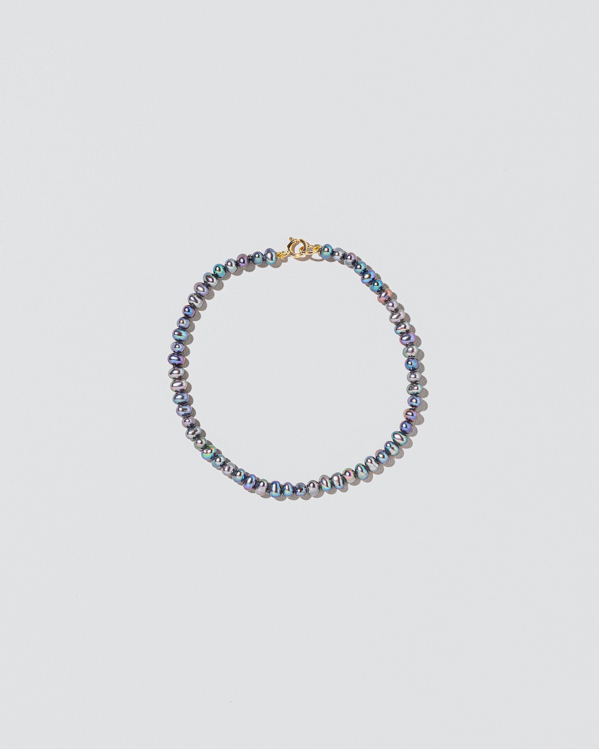 Peacock Seed Pearl Bracelet on light color background.