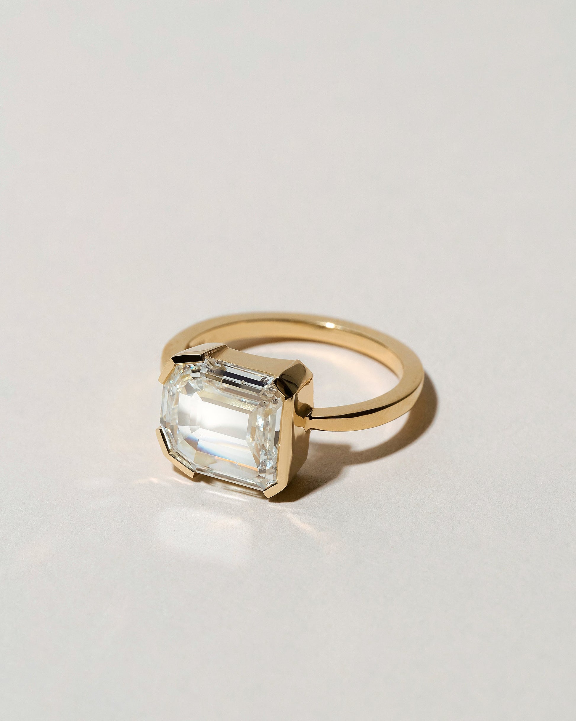 View from the side of the Shield Step Cut Diamond Ring on light color background.