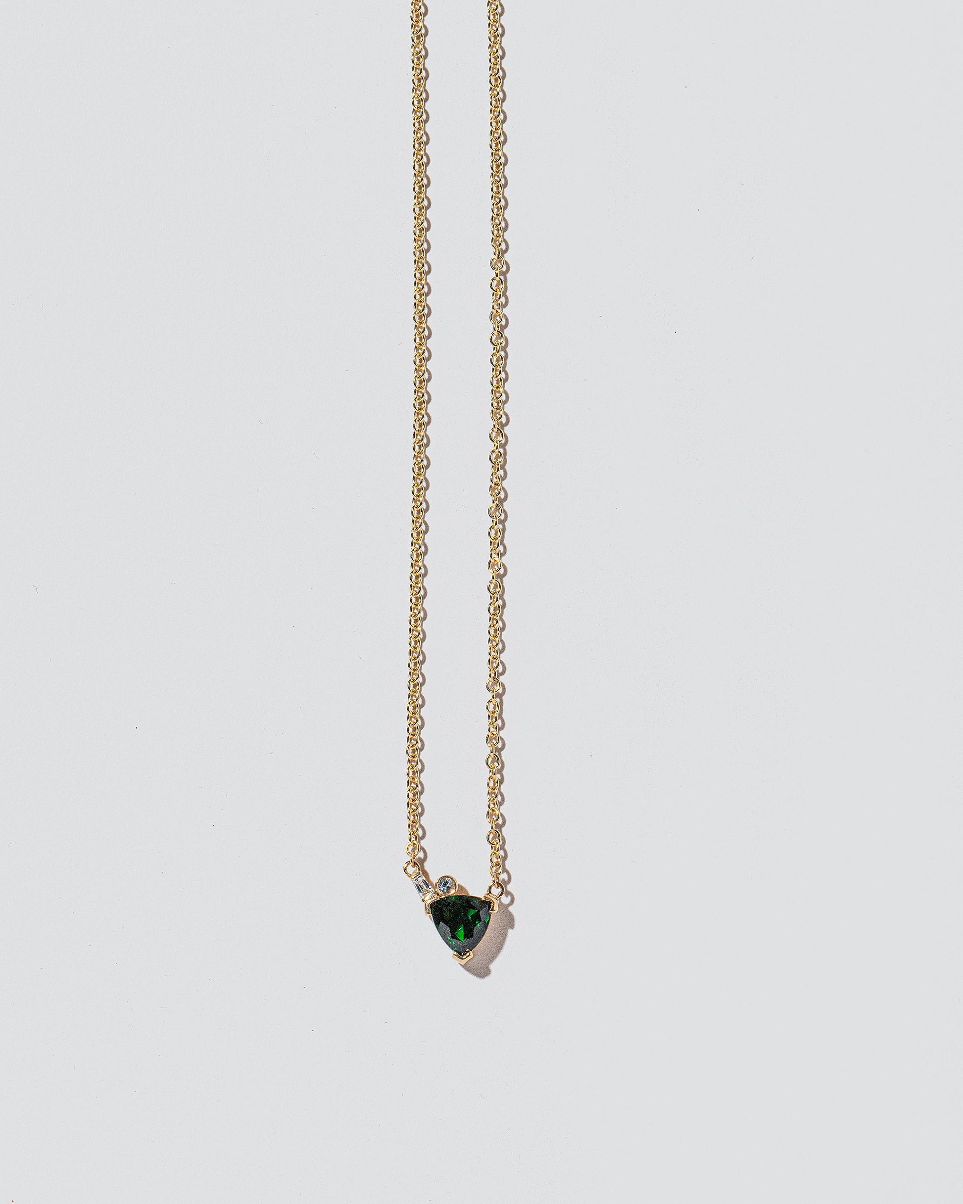  Rise Necklace on light color background.