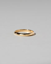 Gold 2mm Knife Edge Band on light color background.