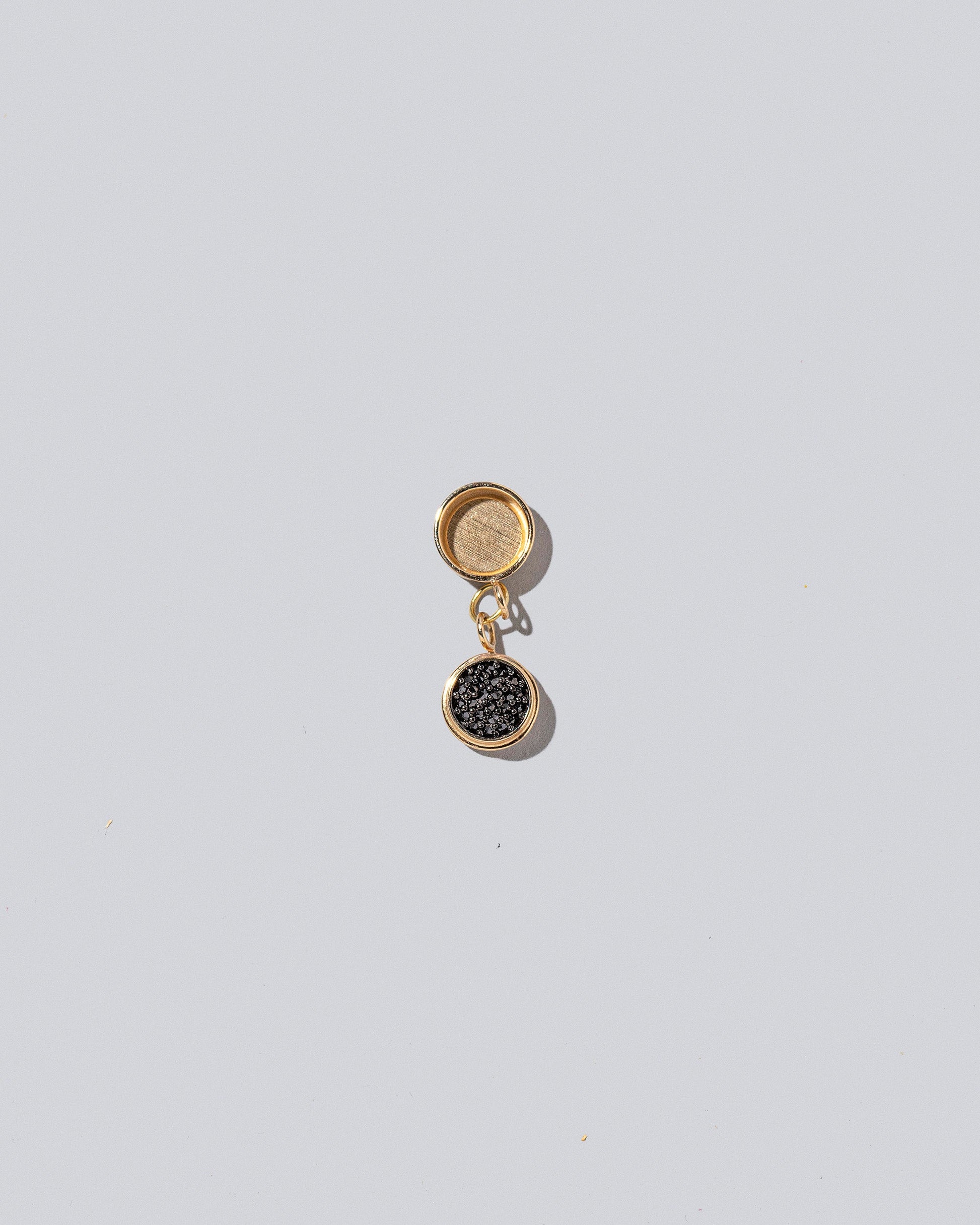 Caviar Charms on light color background.