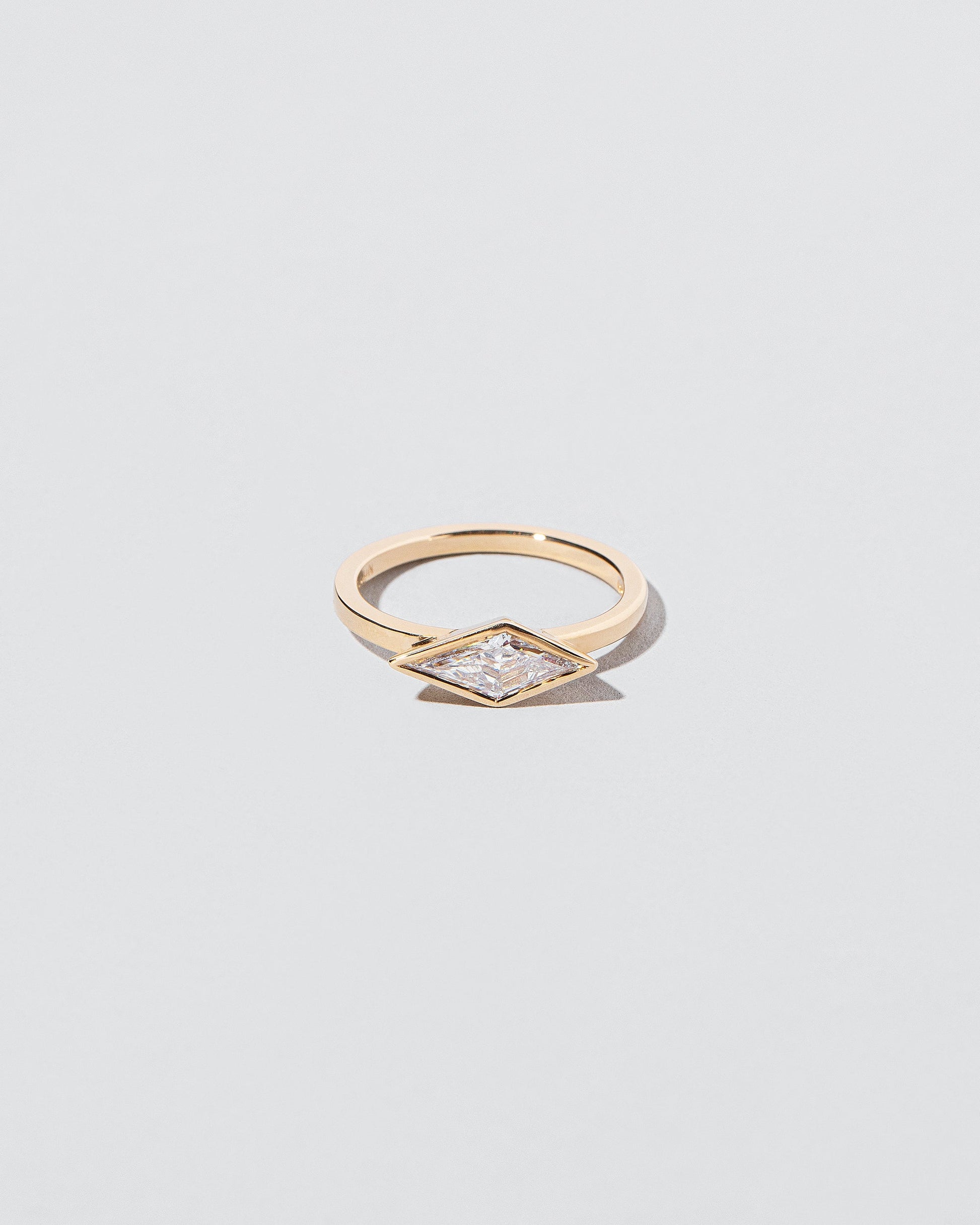Atomism Ring on light color background.