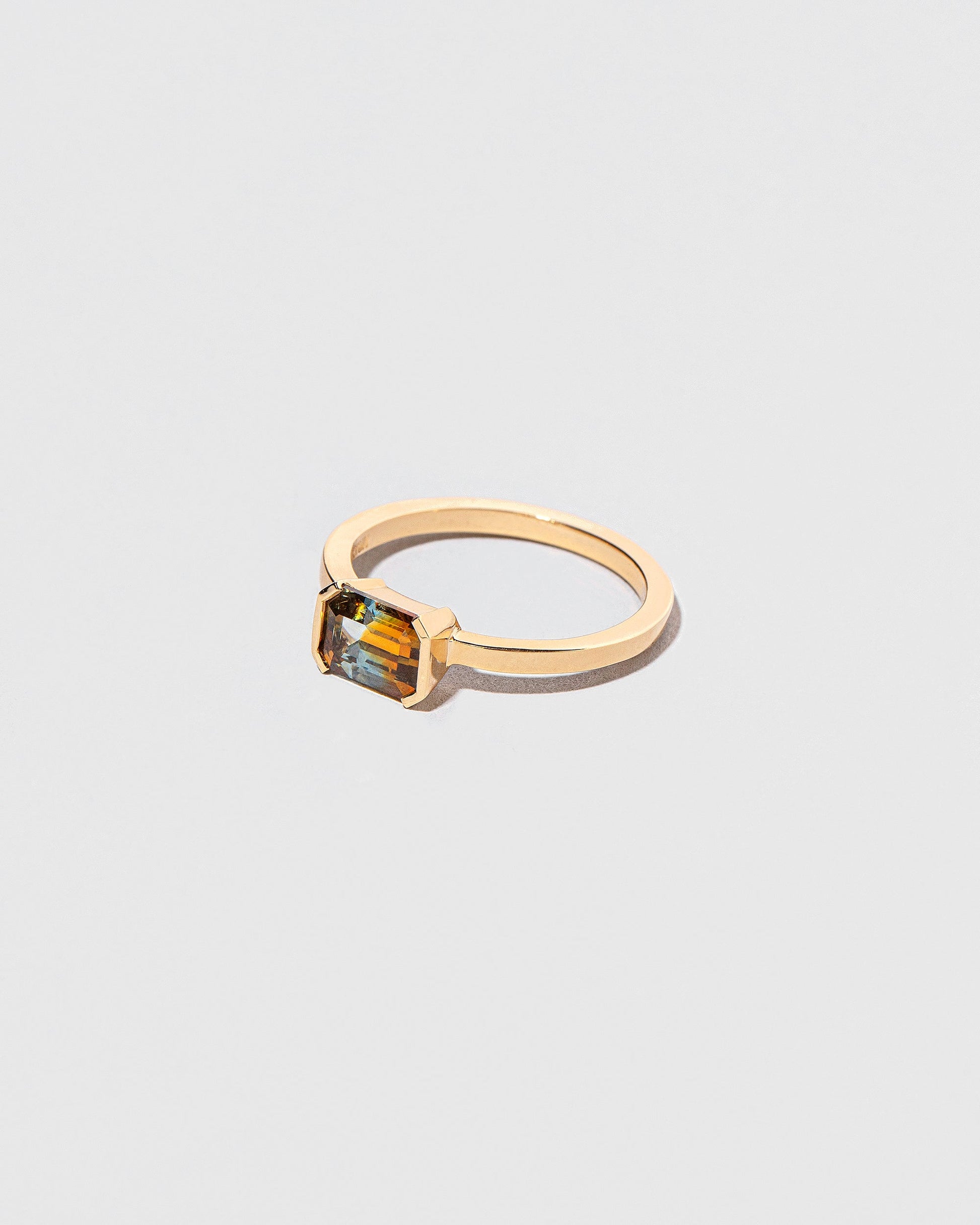 View from the side of the Elowan Ring on light color background.